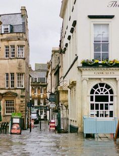 an empty city street is shown in the rain