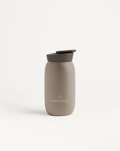 a gray glass jar with a black lid sitting on a white surface, next to the words watercolorhop