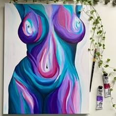 an abstract painting with purple and blue colors on the canvas next to paintbrushes