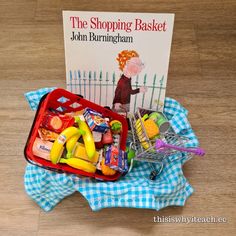 the shopping basket is filled with toys and books