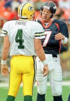 two football players are talking on the field