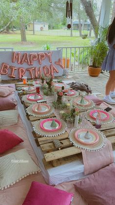 a table set up for a birthday party with plates and napkins on top of it