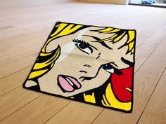 a rug on the floor with a woman's face painted on it