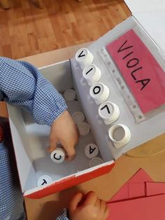 a child is playing with legos in a box that has words written on it