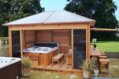 a hot tub sitting next to a wooden gazebo