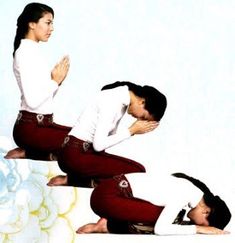 two people in red pants and white shirts are doing yoga