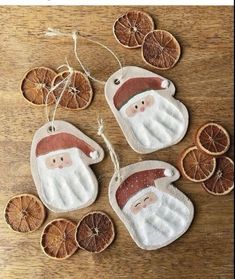 orange slices and santa clause ornaments on a wooden table