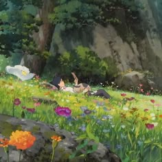 two people laying in the grass near flowers