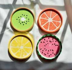 four slices of watermelon, lemon, and grapefruit in small bowls