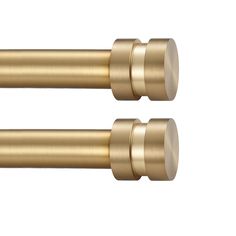 two brass colored handles on a white background