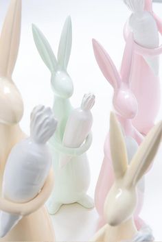 several small plastic rabbits sitting next to each other