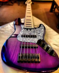 a purple electric guitar sitting on top of a table