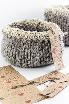 two knitted baskets sitting next to each other