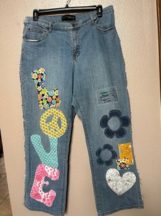 a pair of jeans with patches on them