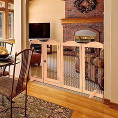 a living room with a fireplace and dining table