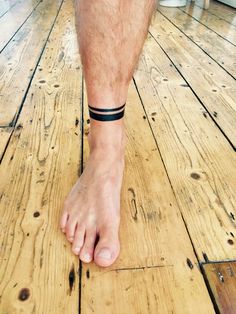 a close up of a person's bare foot on a wooden floor