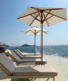 lounge chairs and an umbrella on the beach