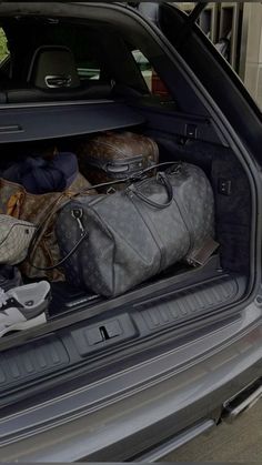 luggage is packed in the trunk of a car