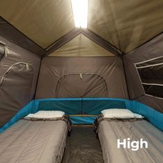 two twin beds in a tent with the sun shining through the roof and side walls