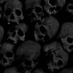 a pile of black skulls sitting next to each other