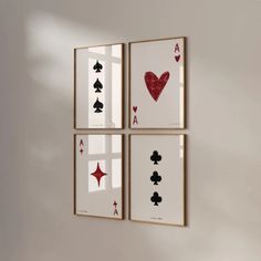 four framed playing cards hanging on the wall