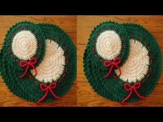 two crocheted christmas hats with red bows on them