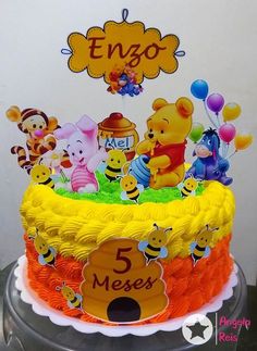 a winnie the pooh birthday cake is decorated with honeybees and other characters