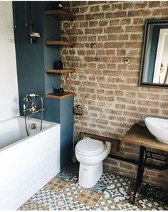 the bathroom is decorated in blue and white with an interesting tile pattern on the floor