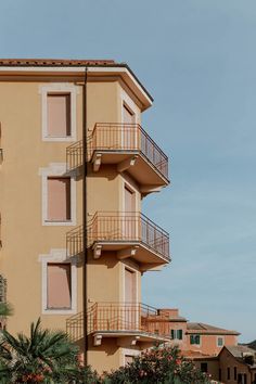 an apartment building with balconies on the second floor