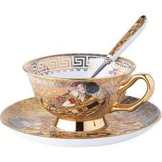 a golden cup and saucer with a spoon in it