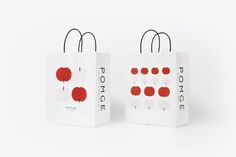 two white bags with red designs on the front and back, one is for pomegranate