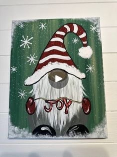 an image of a painting on the wall with snowflakes and santa clause hat