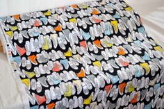 a black and white blanket with colorful hearts on it