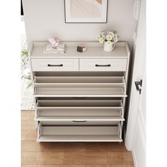 a white dresser with drawers in a room