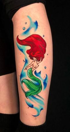 a woman's leg with a tattoo on it that has a little mermaid in the water