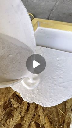 a close up of a white cup on top of wood shaving