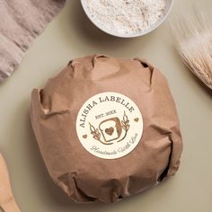 a brown paper bag sitting on top of a table next to bowls and spoons