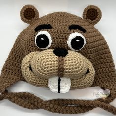 a crocheted brown bear hat with big eyes