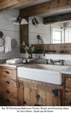 a kitchen with wooden cabinets and white sinks in it's center area, along with hanging lights