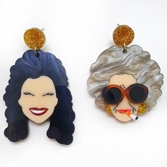 two earrings that have been designed to look like the faces of marilyn monroe and betty smith