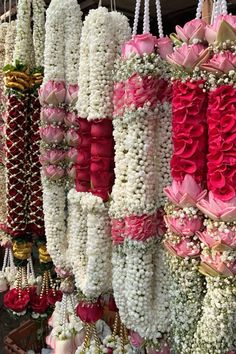 many different types of flowers hanging from hooks