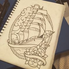 a notebook with a drawing of a ship on it