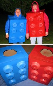 two children in costumes made out of legos, one wearing a red and blue costume