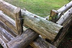 an old wooden fence that is being used as a garden divider for the grass