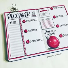 an open planner with the words december written on it and a red apple next to it