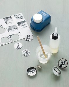 an assortment of crafting supplies sitting on a wooden table with pictures and buttons in the background