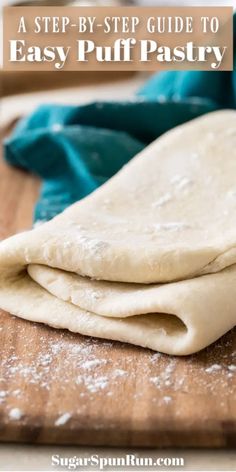 a wooden cutting board topped with uncooked pita bread