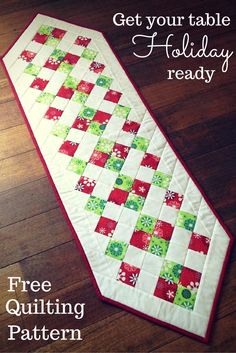 a red and green table runner sitting on top of a wooden floor