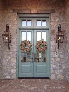 two double doors with wreaths on them