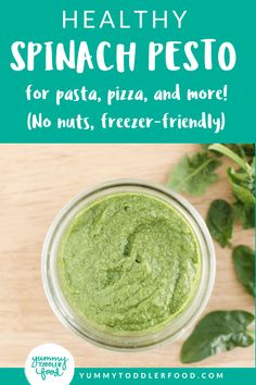 spinach pesto in a glass jar with text overlay that reads healthy spinach pesto for pasta, pizza, and more no nuts, freeze - friendly